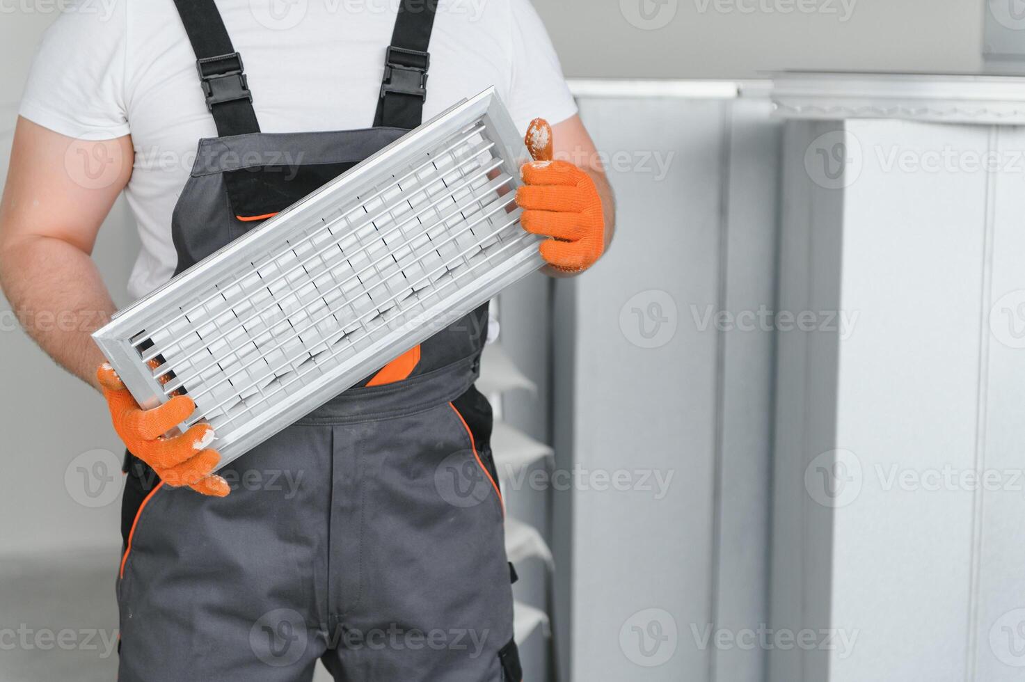 Worker holding air filter for installing in the office ventilation system. Purity of the air concept. photo