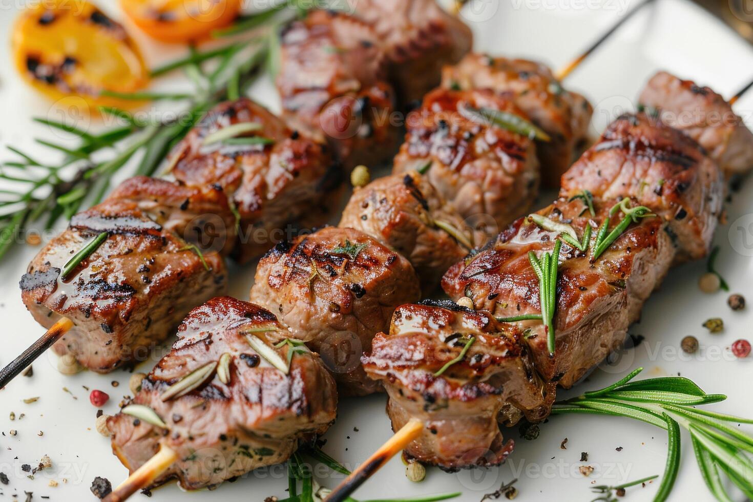 Tasty grilled meat skewers seasoned with rosemary and pepper, great for barbecues and outdoor grilling in the summer. Perfect meal for warm days. photo