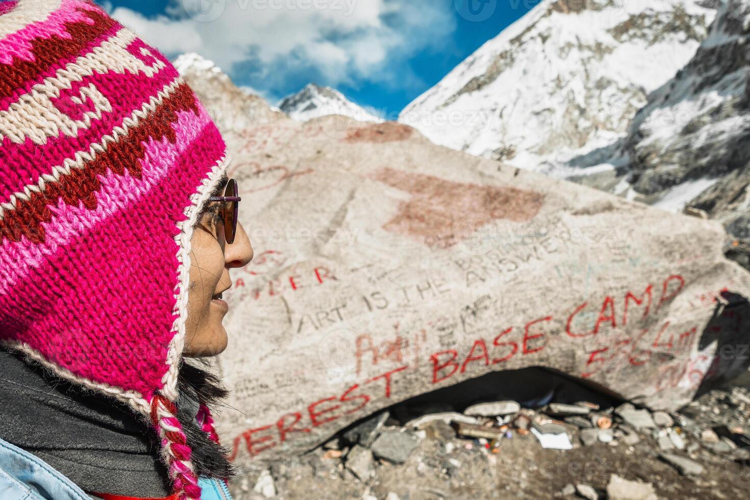Close up portrait woman trekker smile joyful after reaching EBC in Himalayas mountains. Nepal travel guide photo