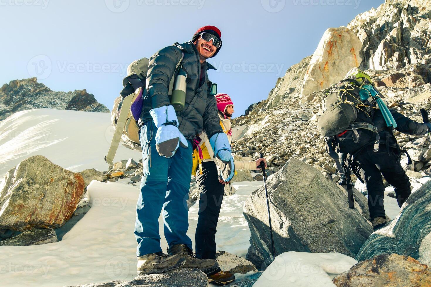 Male guide and caucasian tourist woman together cross mountain pass viewpoint on Himalayas trekking EBC. Nepalese male guide leading tourist client in Sagarmatha national park photo