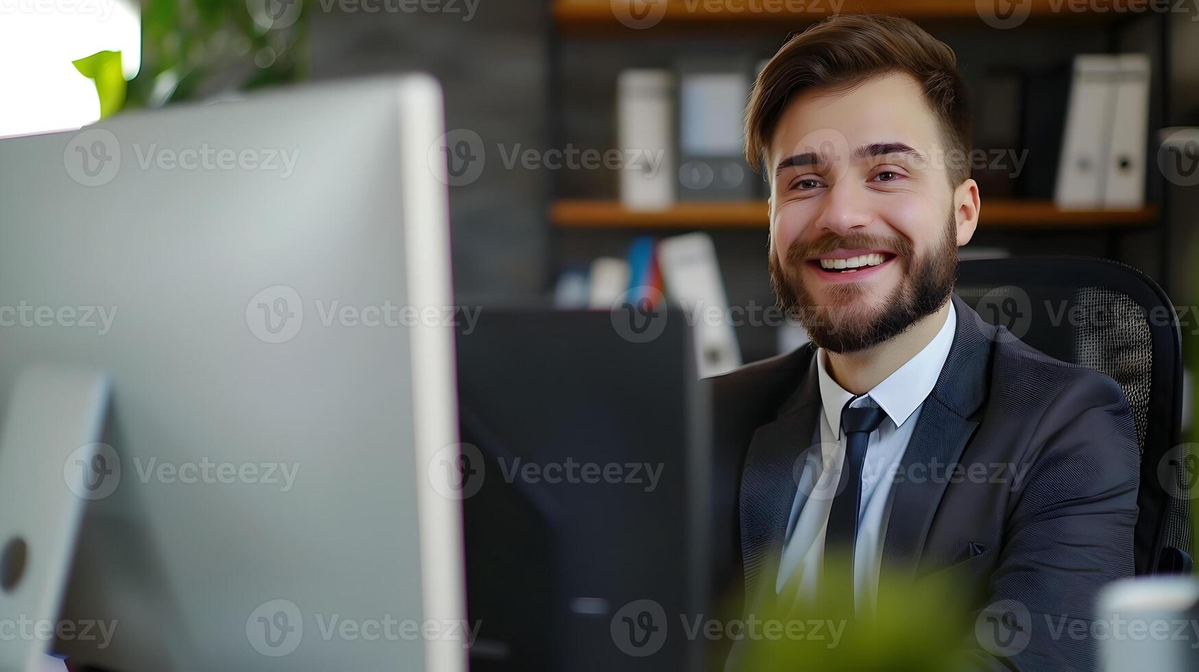 Young Confident Businessman Working Diligently at His Desk in the Office photo