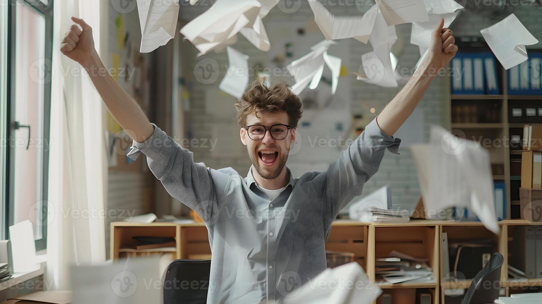Joyful Office Worker Celebrating Accomplishments with Raised Arms photo