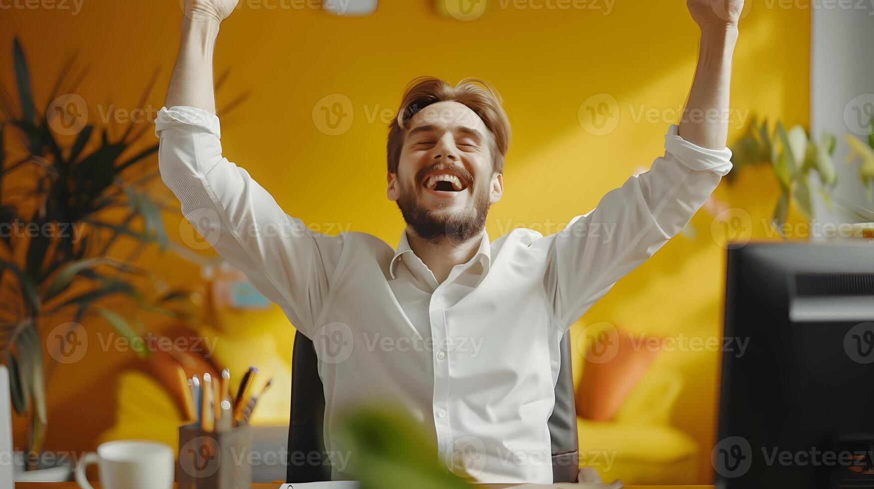 Triumphant Young Professional Celebrating Success and Career Advancement in Modern Office Environment photo