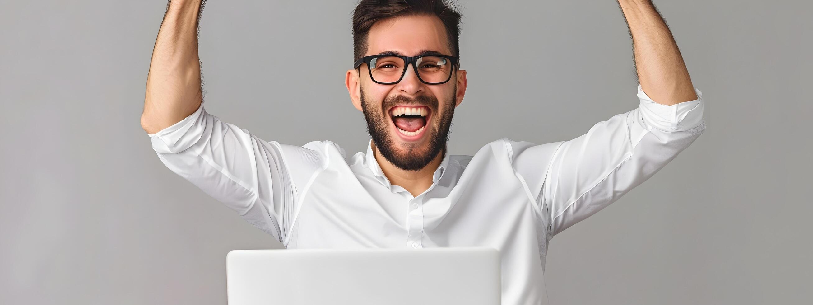 Elated Young Professional Celebrating Success at Computer Workspace photo
