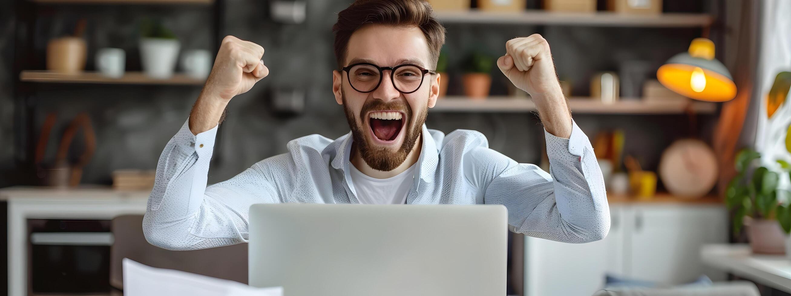 Overjoyed IT Professional Celebrates Successful Workday at Desk photo