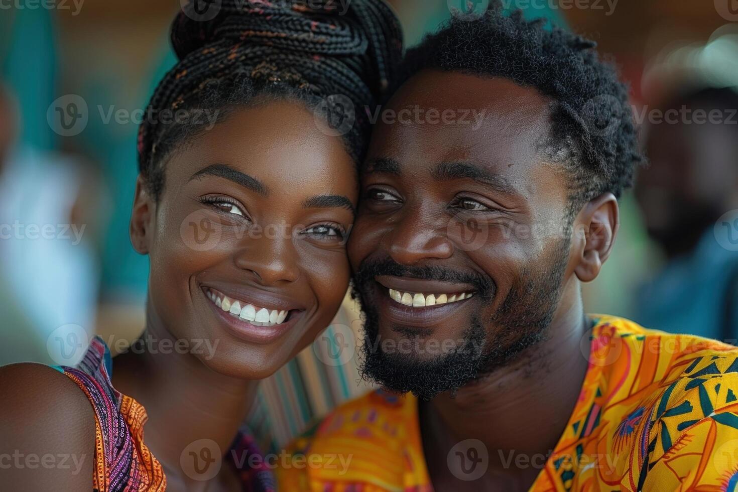 African couple in traditional clothing sharing a joyful moment with genuine smiles, capturing the essence of love and happiness in their cultural context photo