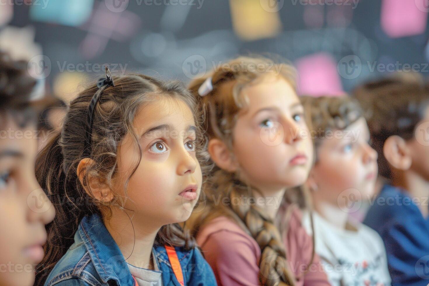 Diverse group of attentive young students listening during a class photo