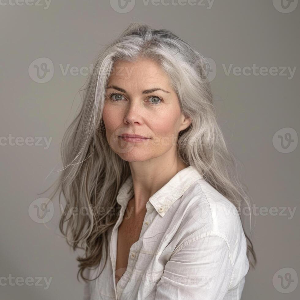 Graceful mature woman with gray hair and serene expression in a portrait photo