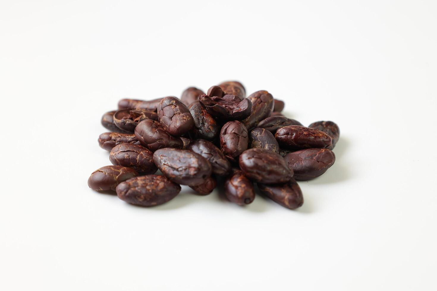 Roasted cocoa beans isolated on white background photo