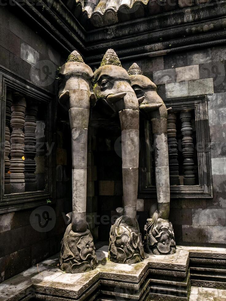 Three elephant reliefs in the temple made of andesite stone symbolize the god Ganesha photo