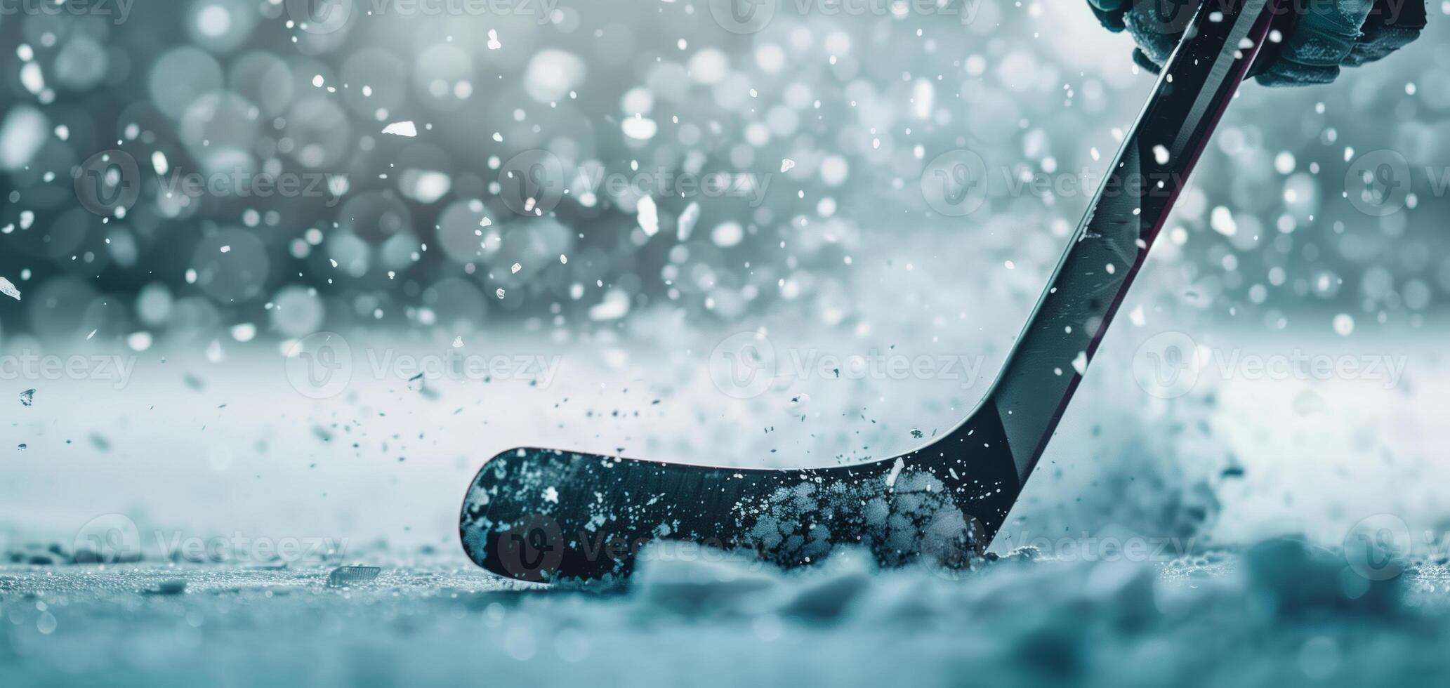 Close-up of an ice hockey stick making contact with the ice, creating a burst of snow and capturing the intensity of the sport. photo