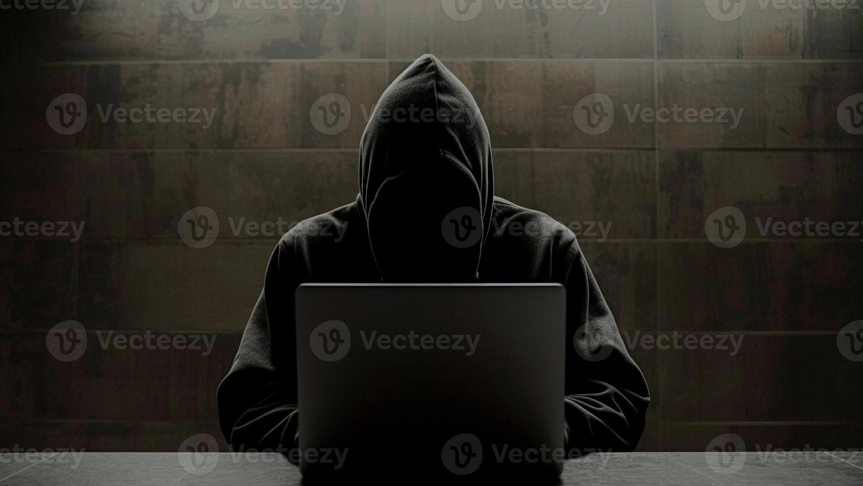 hacker with laptop computer on dark background photo