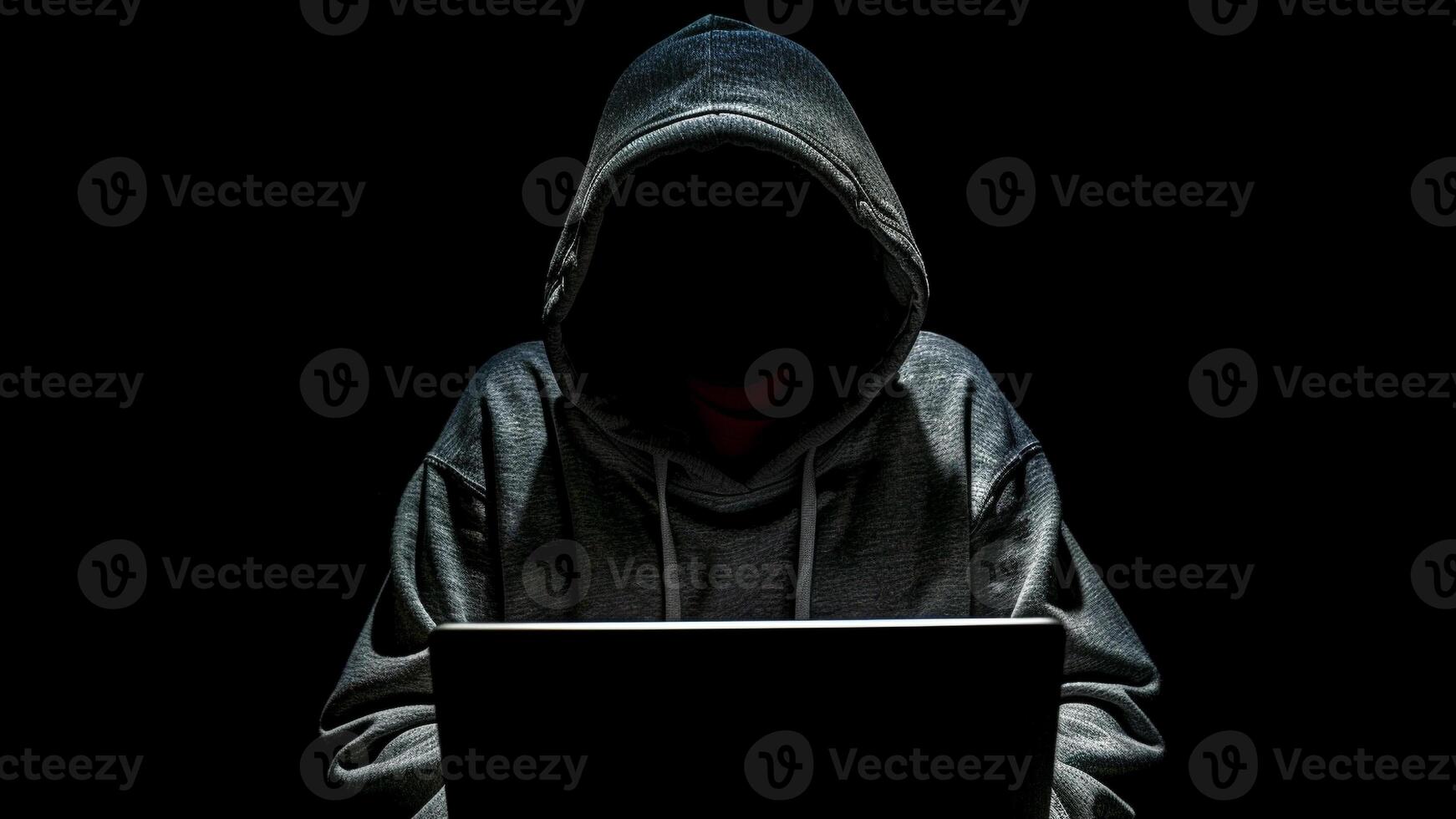 hacker with laptop computer on dark background photo