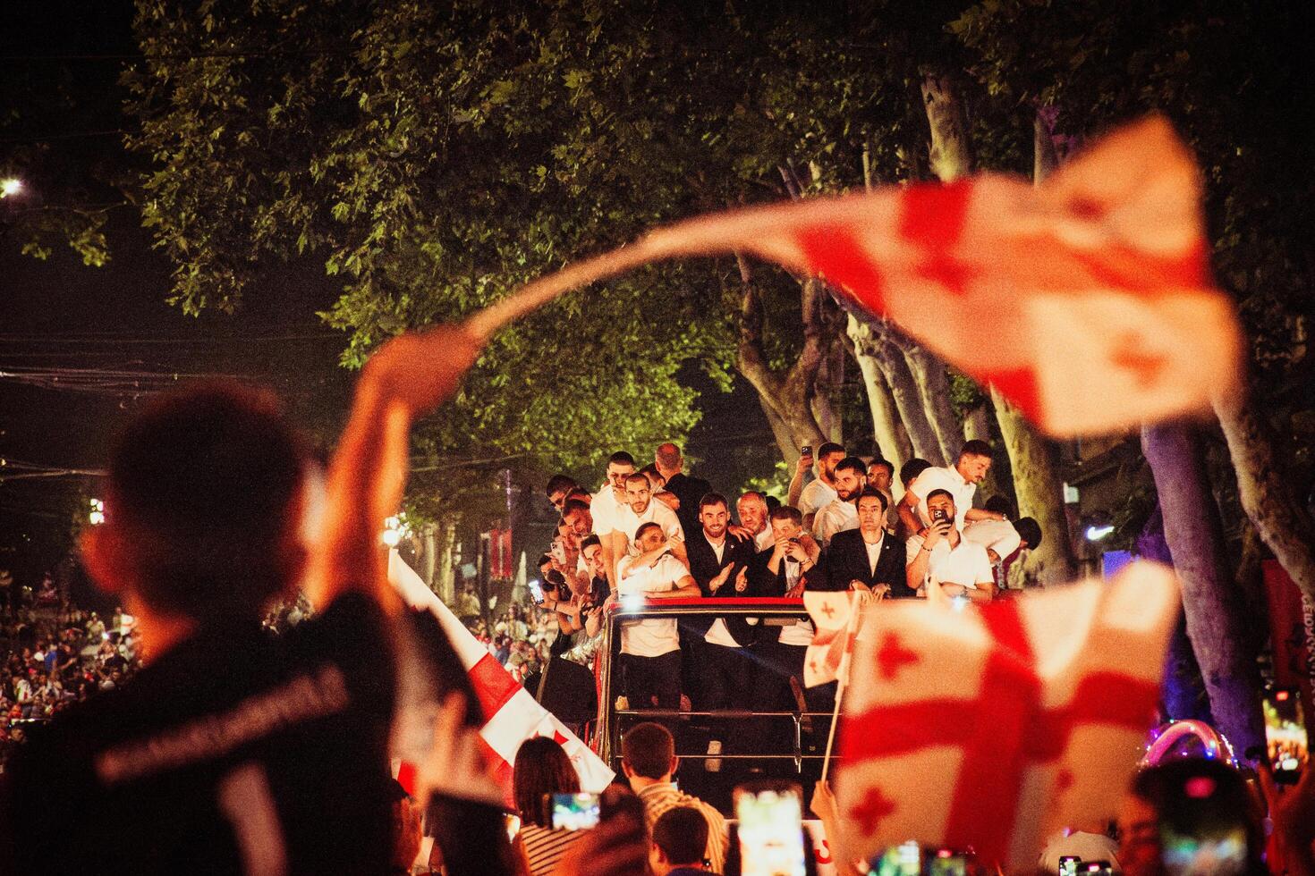 Tbilisi, Georgia - 2nd july, 2024 - Football players on open-roof bus on Georgian national football team arrival home welcome celebrations in capital city Tbilisi streets photo