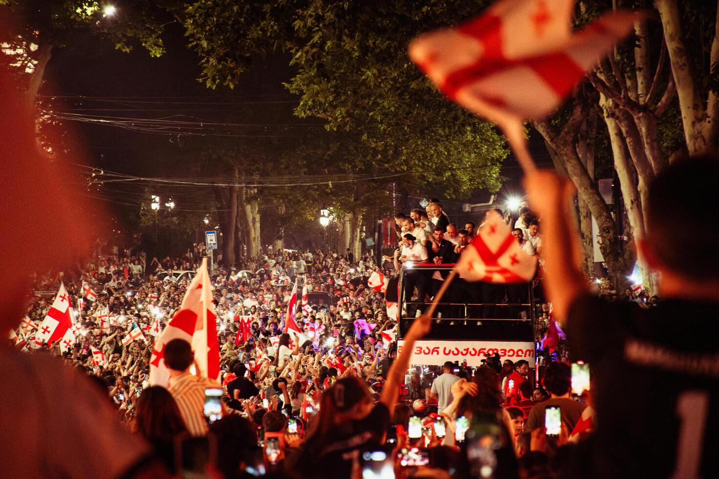 Tbilisi, Georgia - 2nd july, 2024 - Football players on open-roof bus on Georgian national football team arrival home welcome celebrations in capital city Tbilisi streets photo