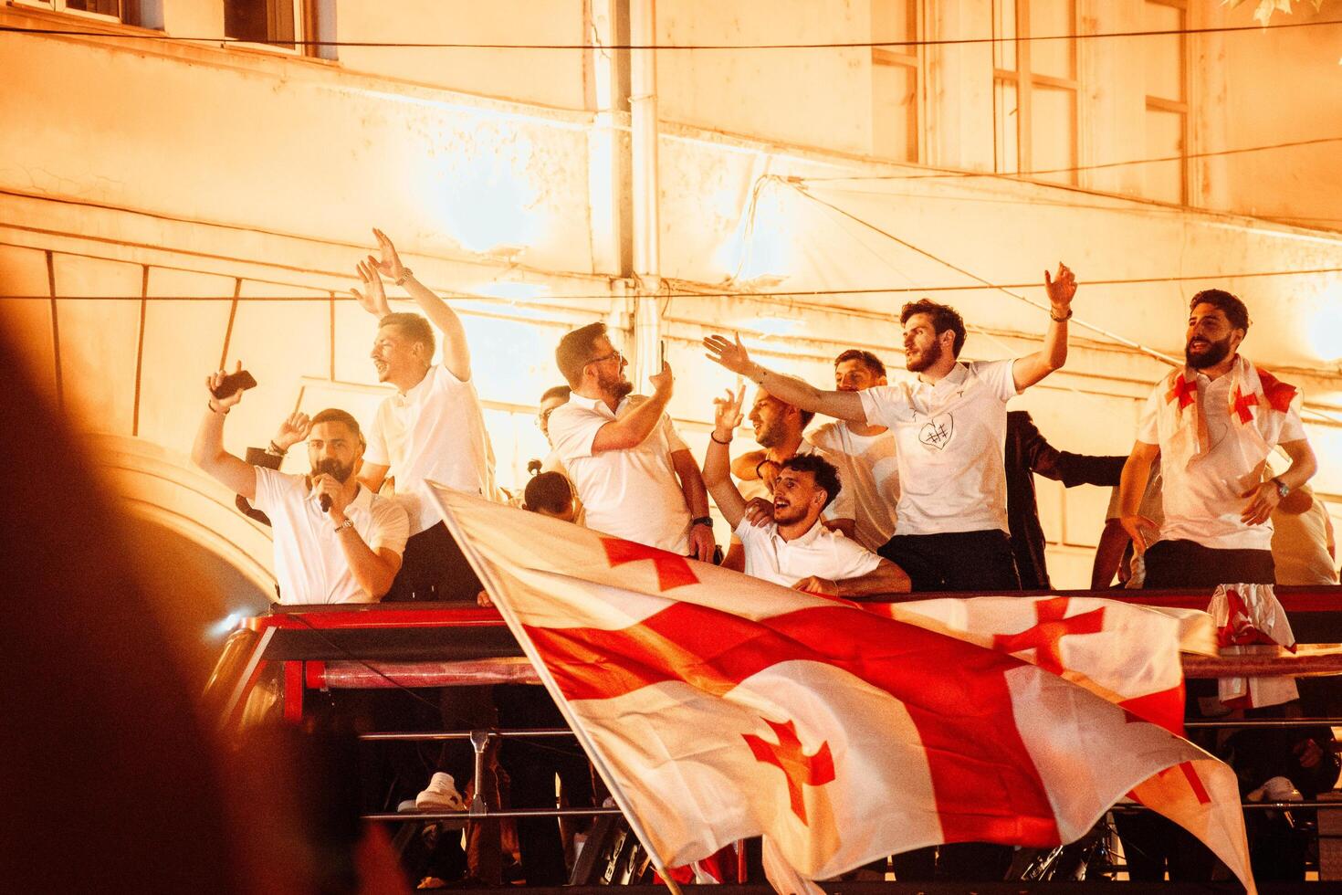 Tbilisi, Georgia - 2nd july, 2024 - Georgian national football team players in open-roof bus wave greets on arrival home welcome celebrations in capital city Tbilisi streets. photo