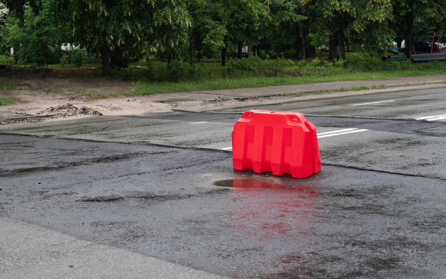 Road repair, laying of new asphalt pavement. barriers to warn drivers photo