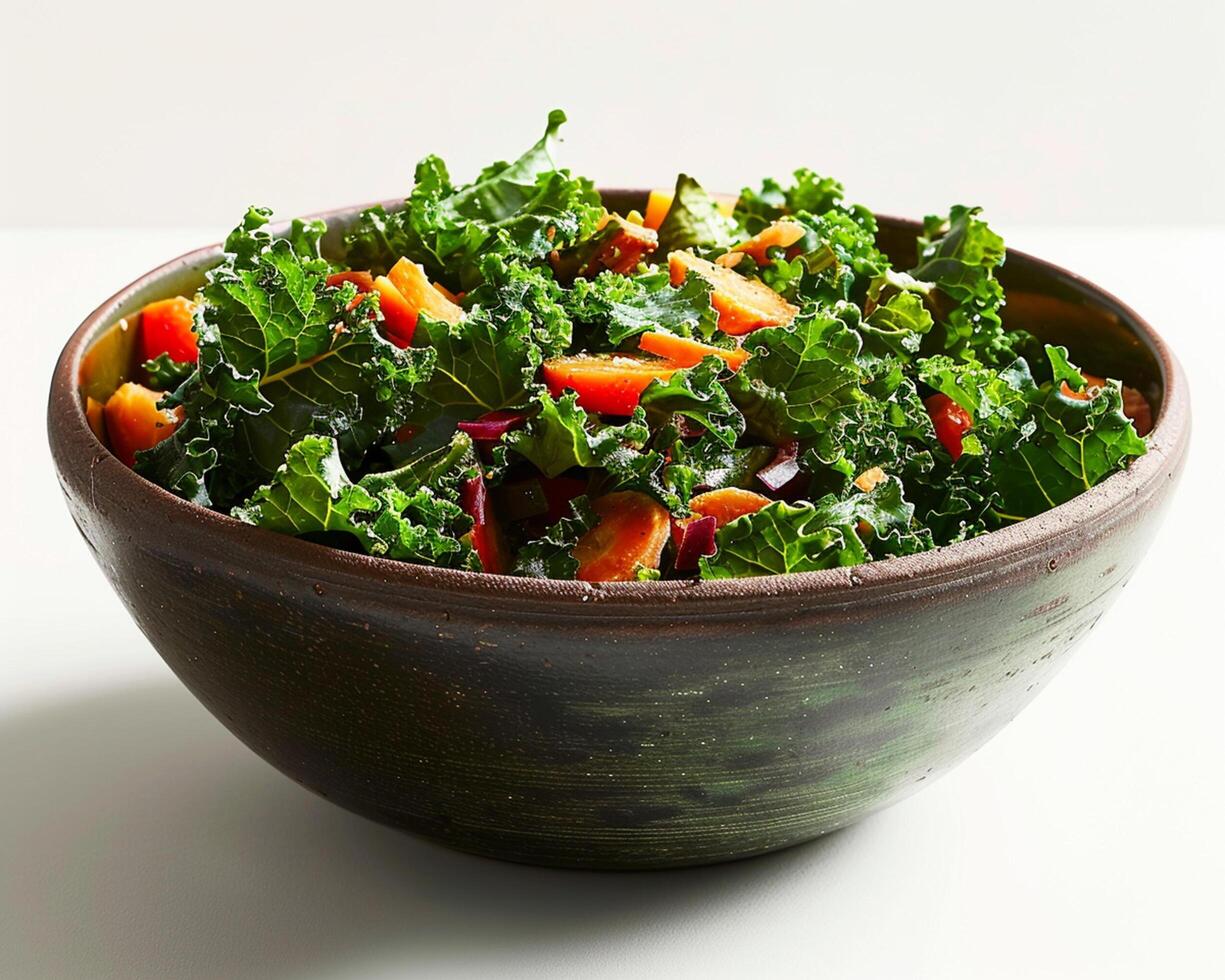 a bowl of kale salad with red peppers and carrots photo