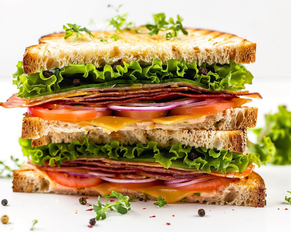 a sandwich with lettuce, tomato, bacon, and cheese photo