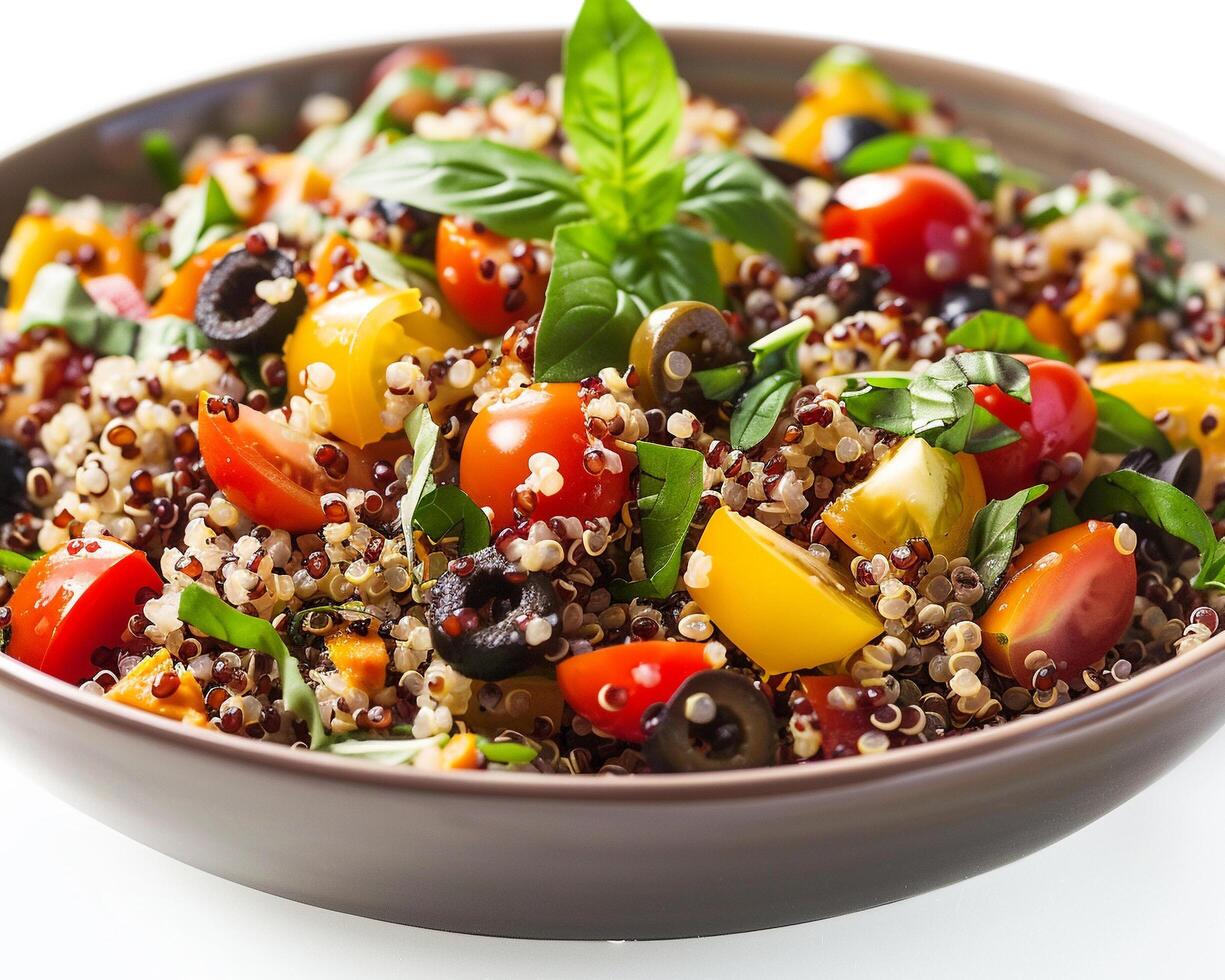 a bowl of quinoa salad with tomatoes, olives and basil photo