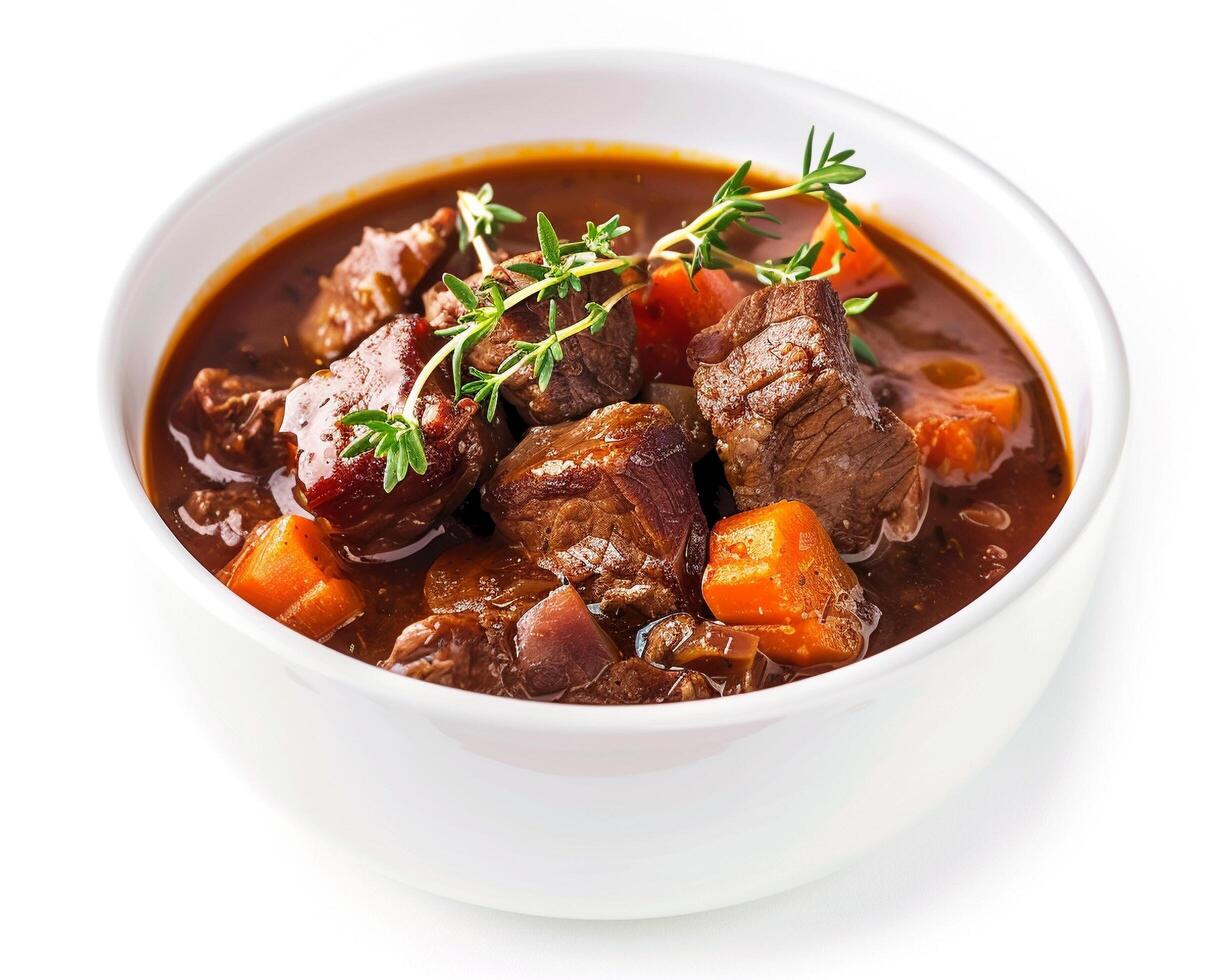 a bowl of beef stew with carrots and herbs photo