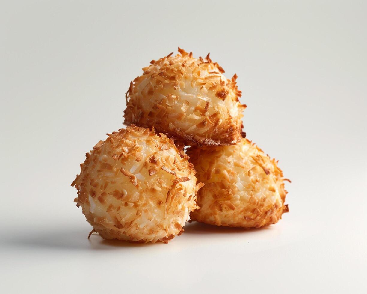 three coconut balls on a white surface photo