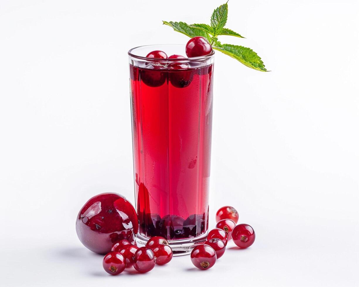 a glass of red liquid with berries and mint leaves photo
