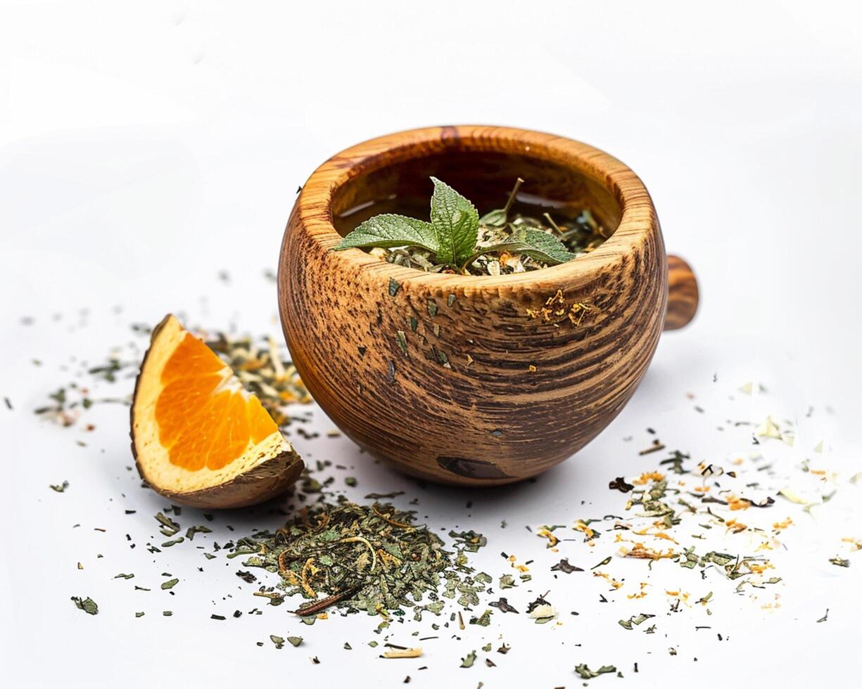 a cup of tea with an orange slice and herbs photo