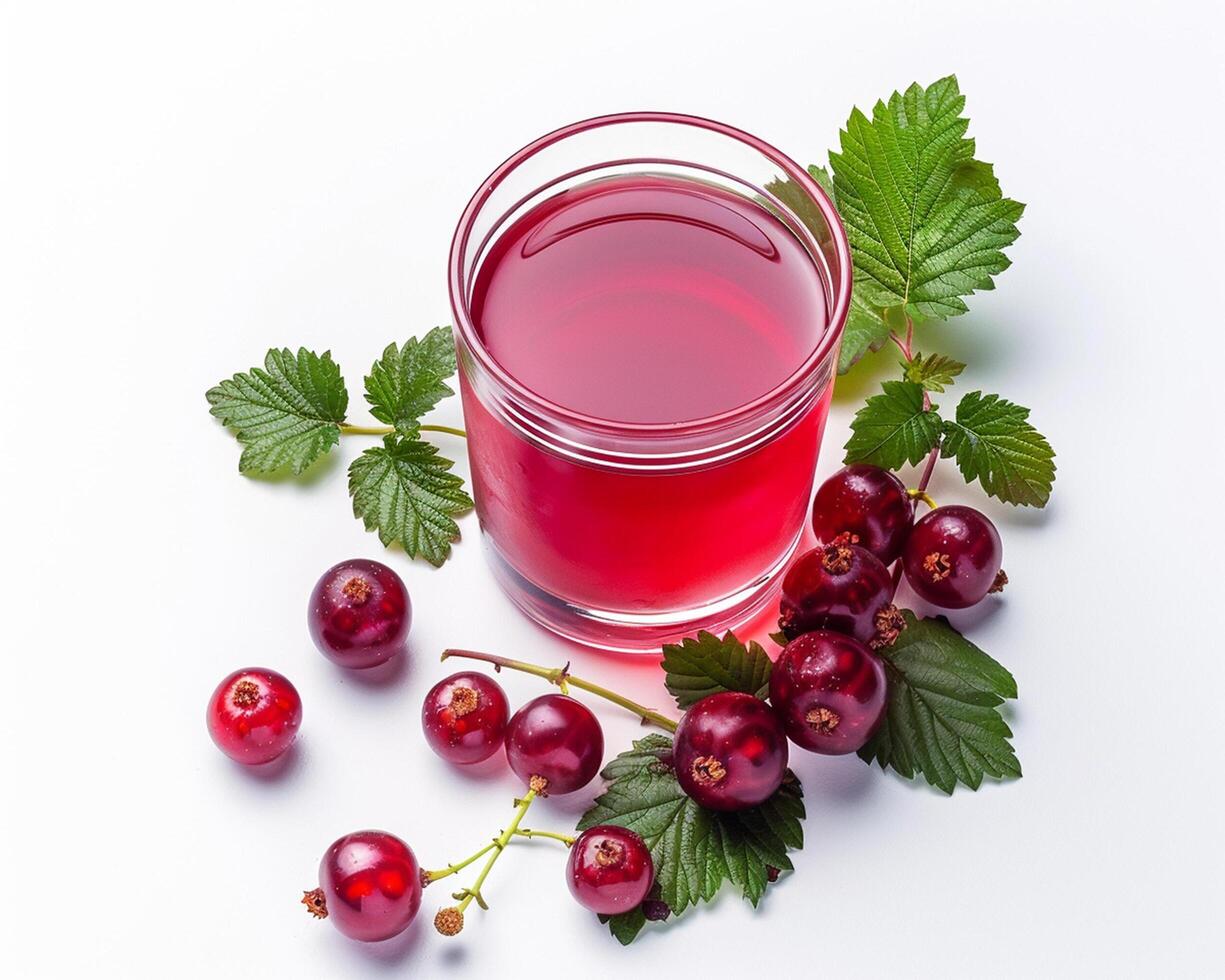 a glass of red currant juice with leaves and berries photo