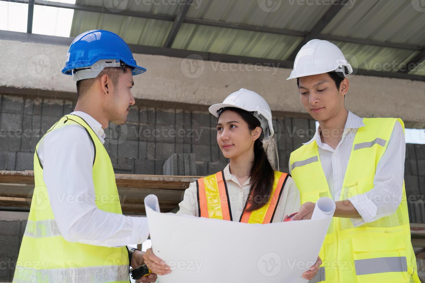 Civil engineer teams meeting working together wear worker helmets hardhat on construction site in modern city. Foreman industry project manager engineer teamwork. Asian industry professional team photo