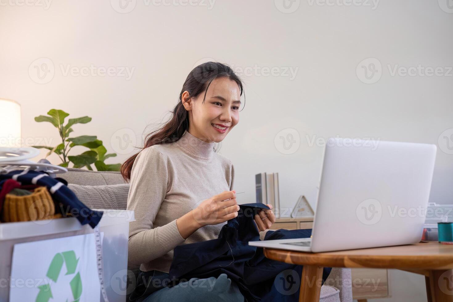 beautiful young woman sewing Repair damaged clothes so that it can be reused. In order to reduce the creation of waste and reduce environmental pollution. photo