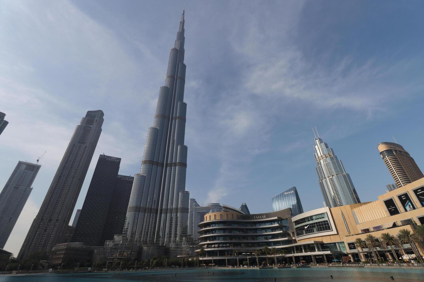 uae, dubai , 1th December 2022 a picture of the burj khalifa with towers and buildings in the night with small lake photo