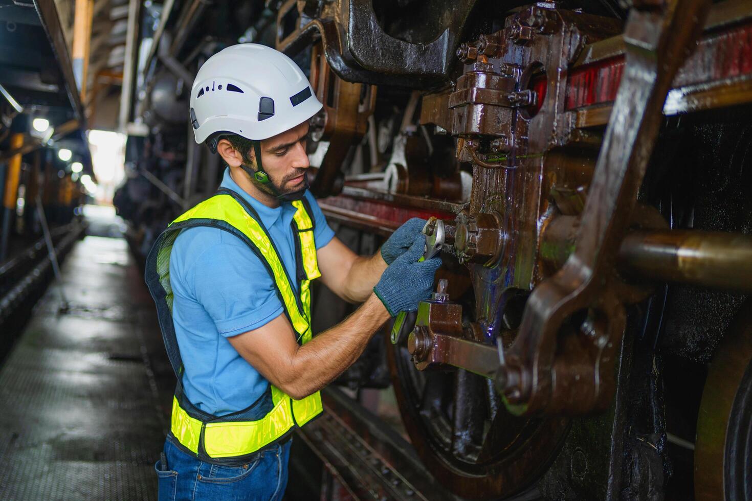 man in a yellow vest is working on a train photo