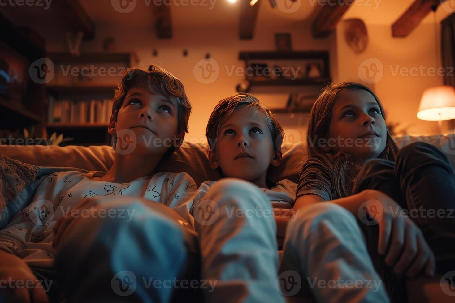 A family is sitting on a couch and watching a movie photo