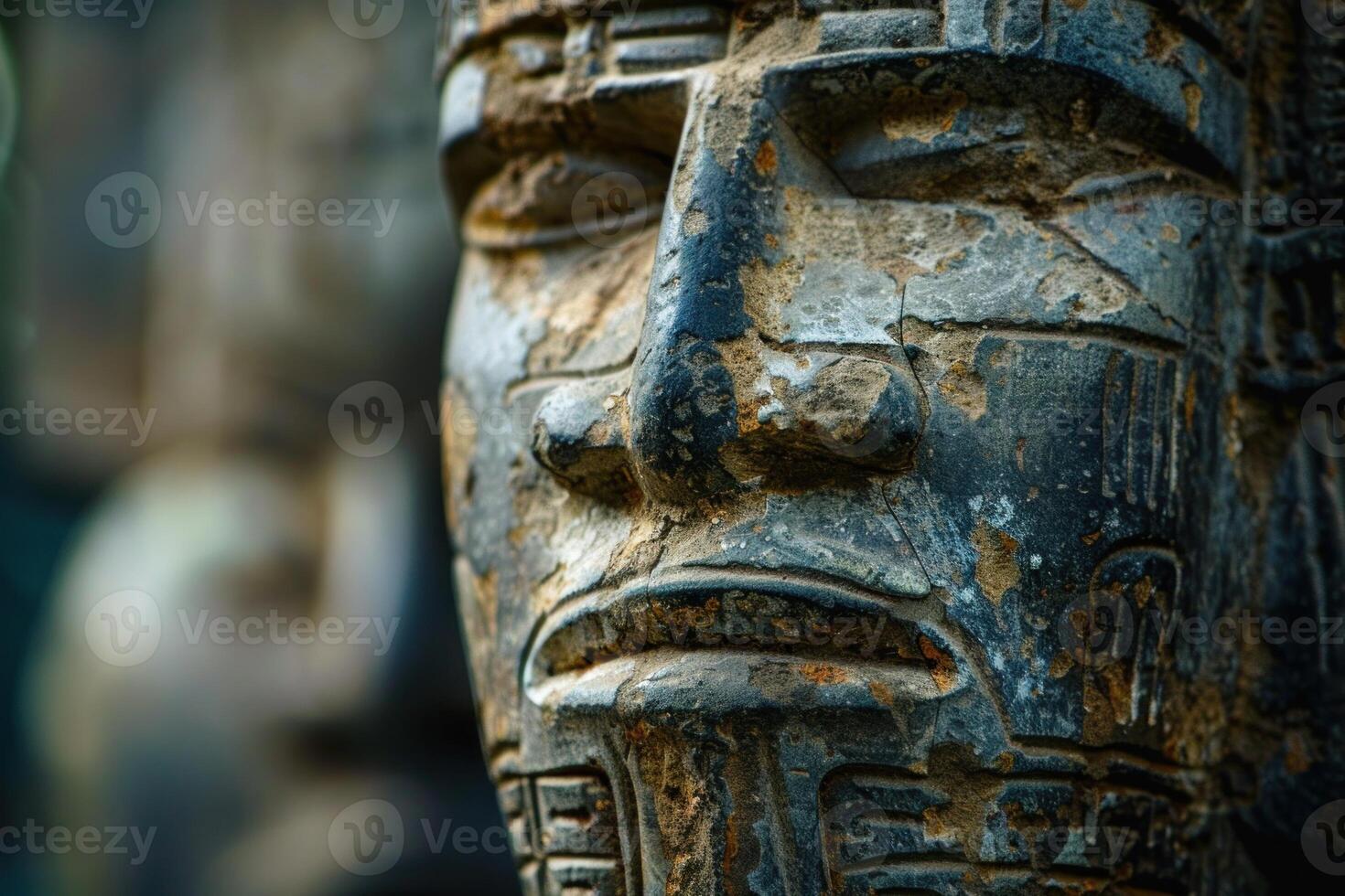 Detailed closeup of an ancient weathered stone statue with intricate carvings photo