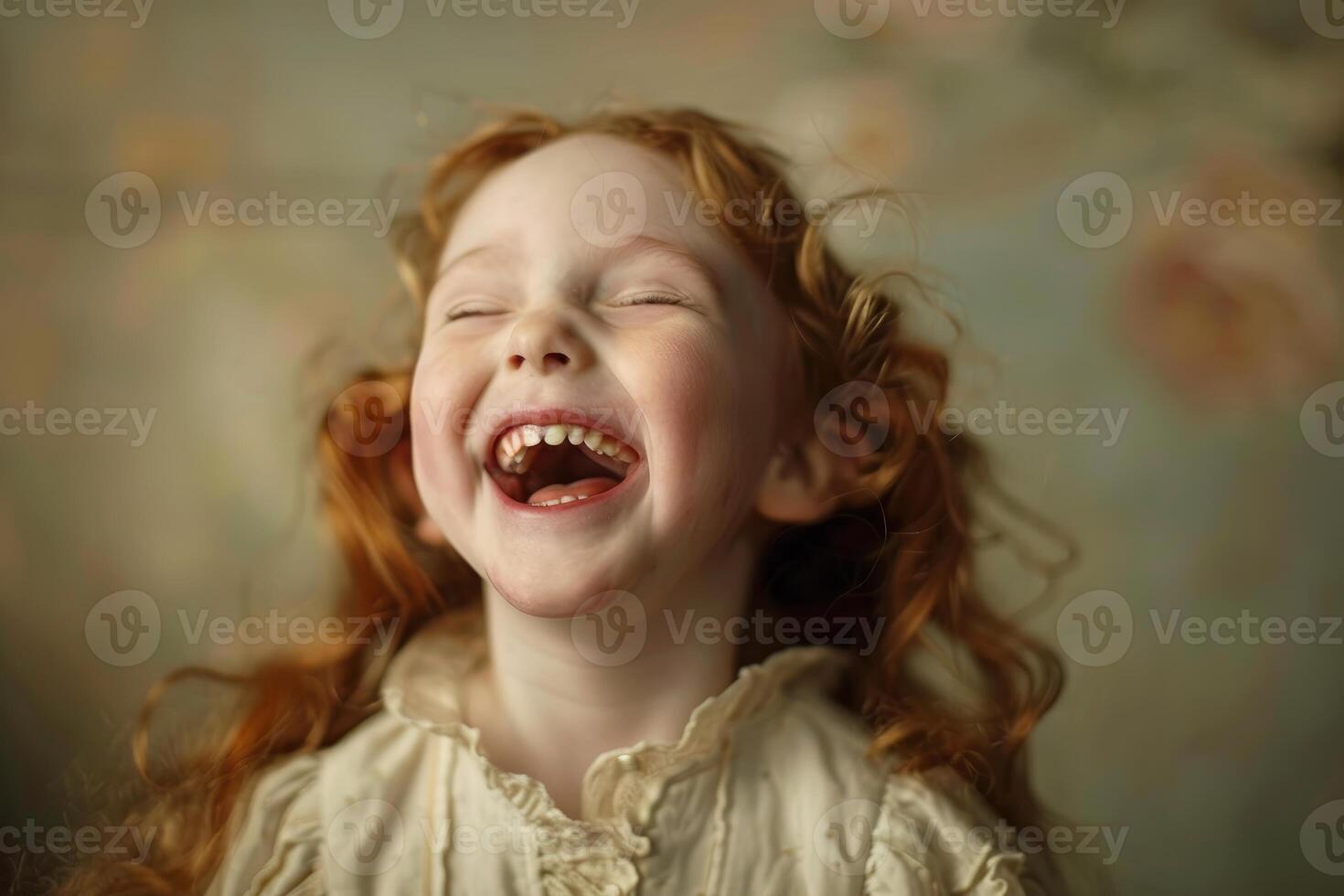 Closeup of a cheerful young girl with curly red hair, laughing heartily photo
