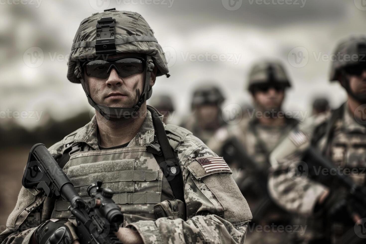 Determined soldier with squad in background photo