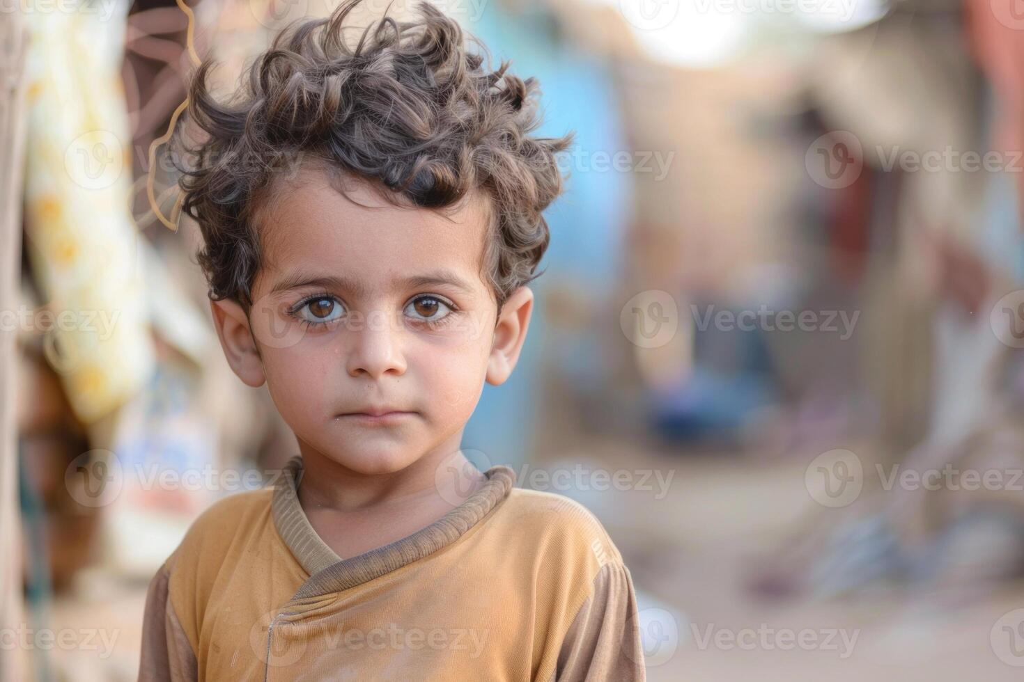 Young boy with curly hair outdoors photo