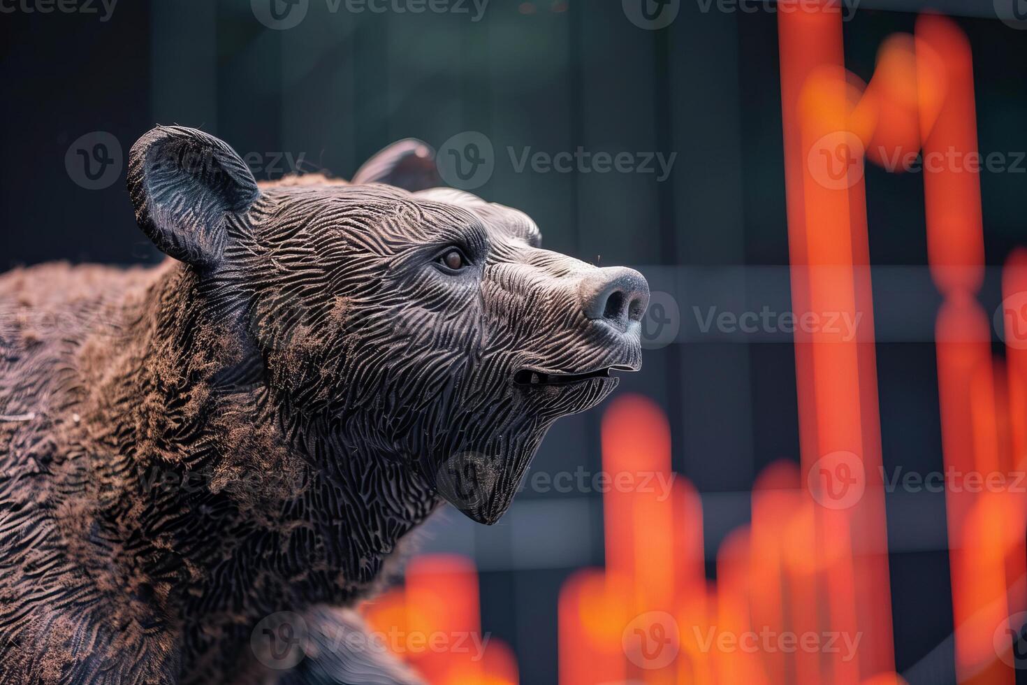 Bear market bear figurine looking at declining stock chart photo