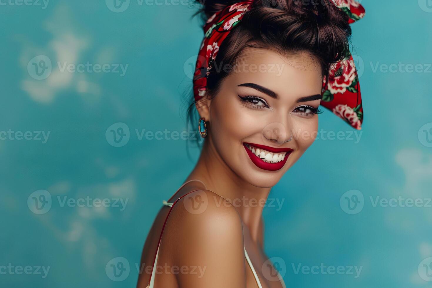 Beautiful brunette model with red lipstick smiling on blue background photo
