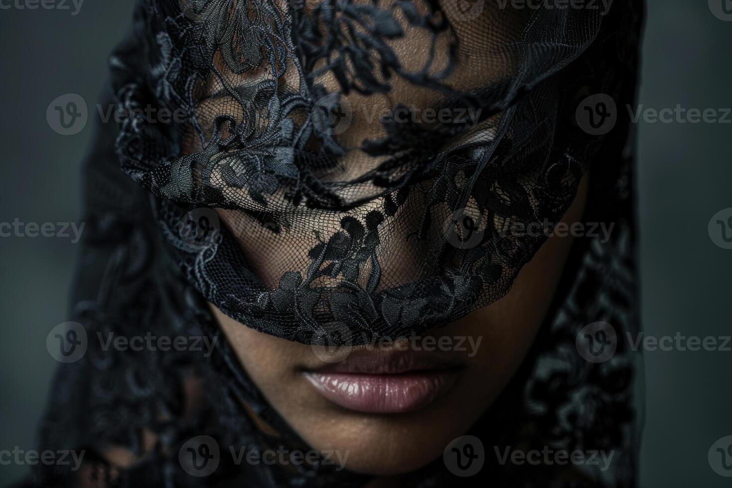 Portrait of a woman wearing a black lace veil covering her face photo