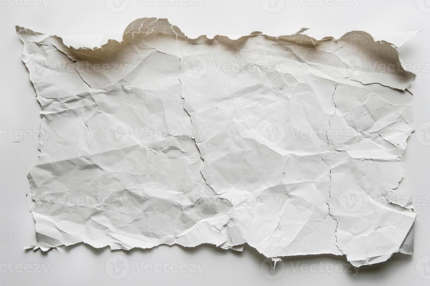White sheet of paper is full of creases and folds photo