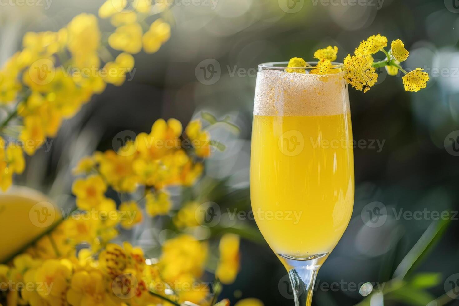 Refreshing yellow cocktail standing near orchids in bloom photo