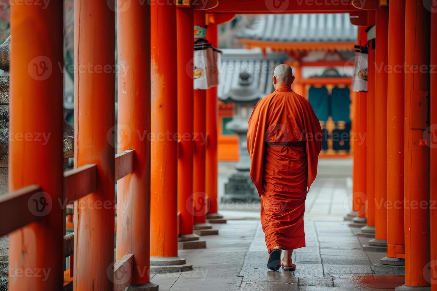 Buddhist monk wearing orange robe walking at japanese temple photo