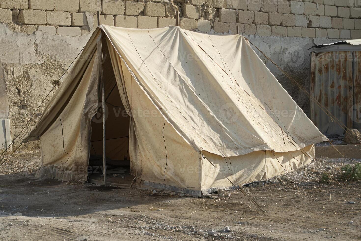 Abandoned canvas tent in deserted area photo