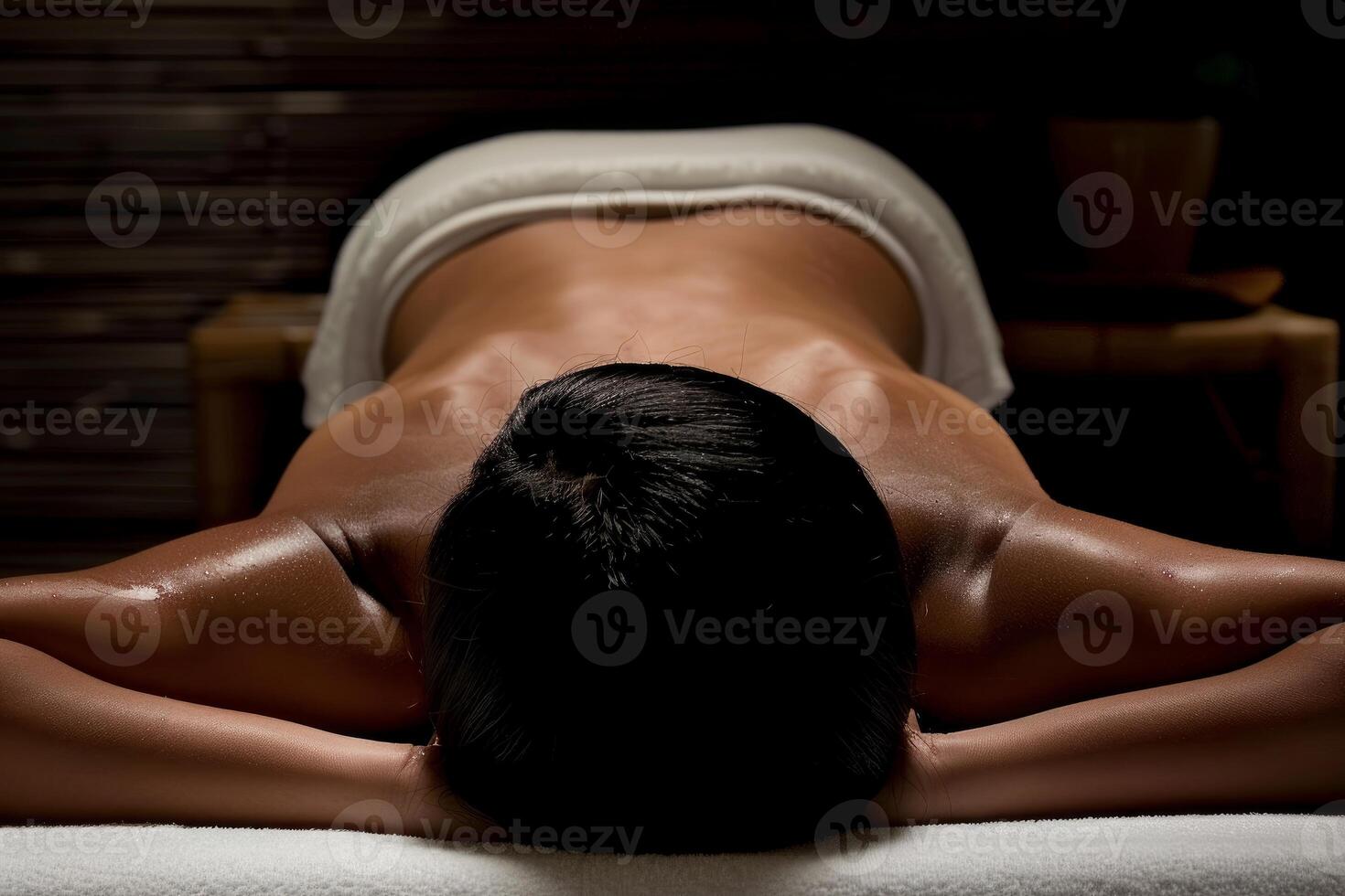 Relaxation in darkness, woman enjoying spa massage photo