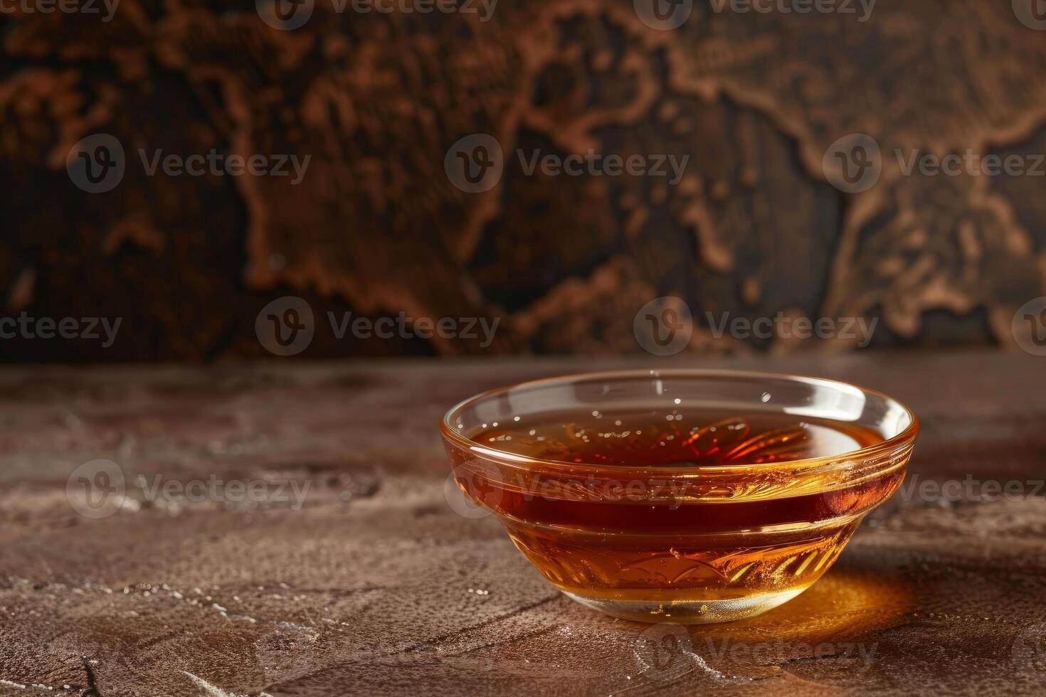 Golden honey on textured table with world map background photo