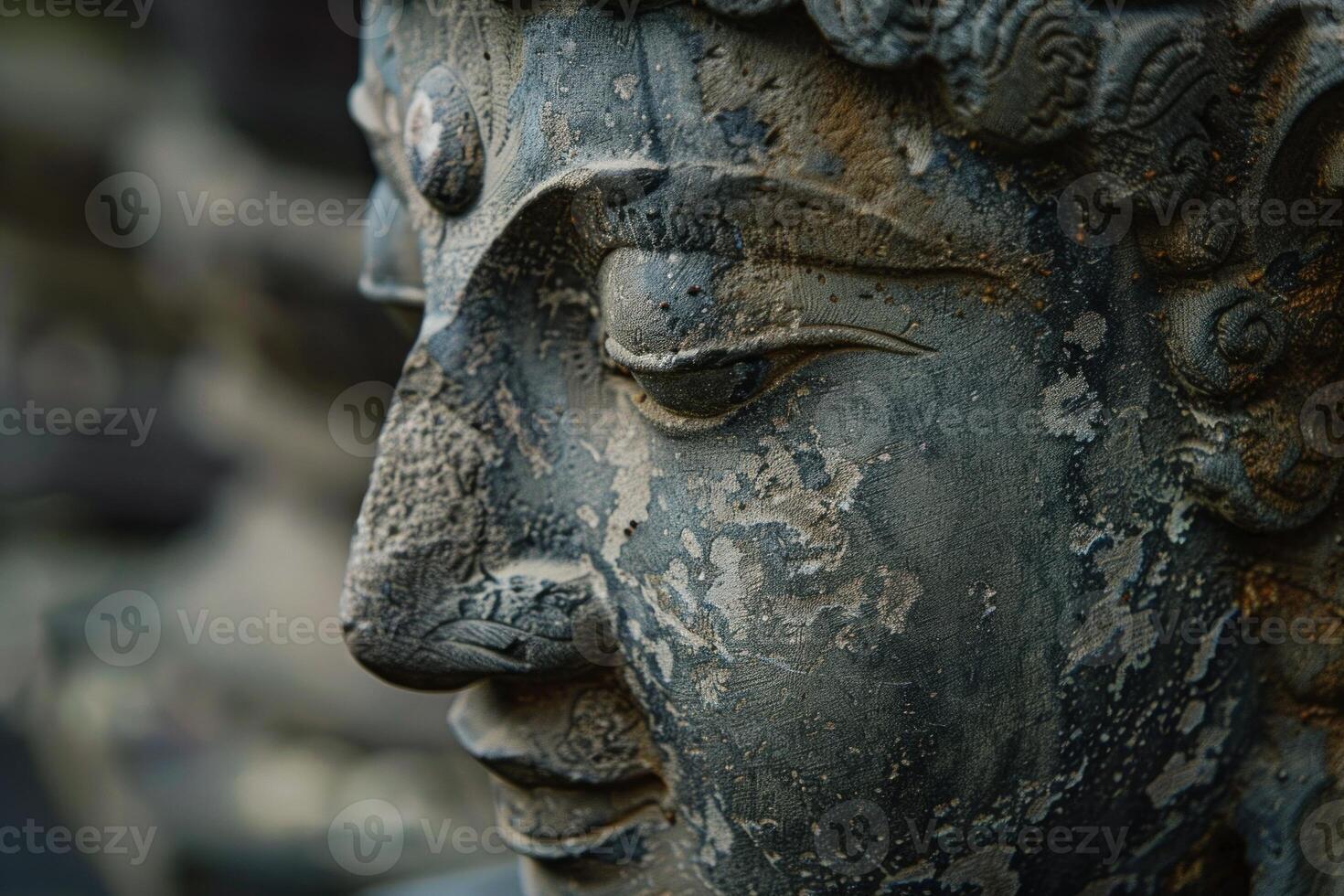 Ancient stone carved face in closeup photo