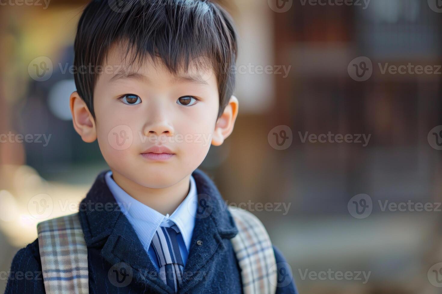 Young boy with a thoughtful expression in school uniform photo