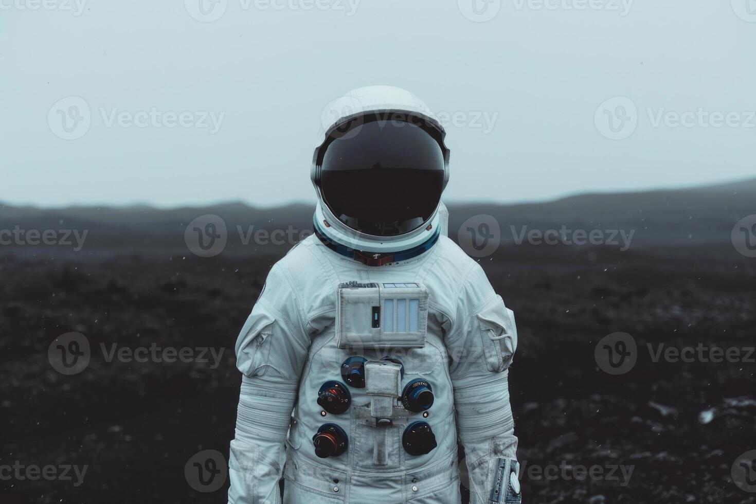 Astronaut in space suit standing on alien terrain photo
